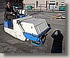 Day 22 - A mini-sweeper sweeps up my shadow as it cleans the paved portion of the lot.