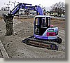 Day 26 - The purple excavator shovels and grades at the same time.